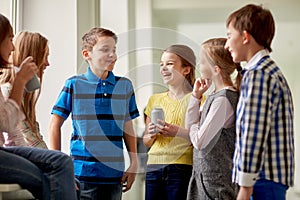 Group of school kids with soda cans in corridor