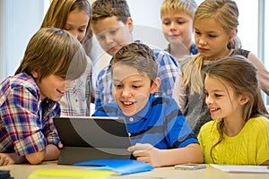 Group of school kids with tablet pc in classroom