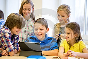 Group of school kids with tablet pc in classroom