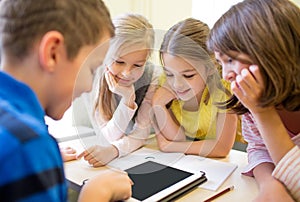 Group of school kids with tablet pc in classroom