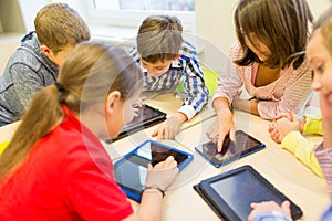 Group of school kids with tablet pc in classroom