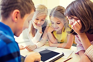 Group of school kids with tablet pc in classroom