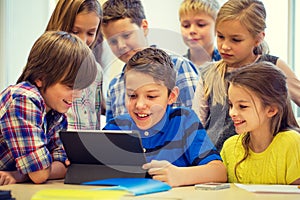 Group of school kids with tablet pc in classroom