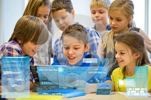Group of school kids with tablet pc in classroom