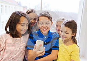 Group of school kids taking selfie with smartphone