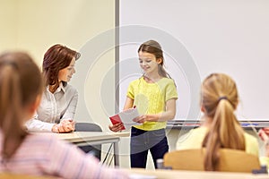 Group of school kids with teacher in classroom