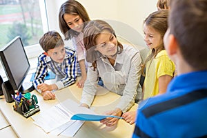 Group of school kids with teacher in classroom