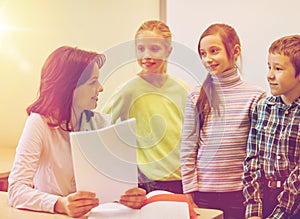 Group of school kids with teacher in classroom