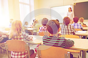 Group of school kids and teacher in classroom