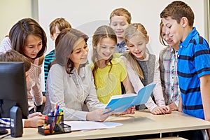 Group of school kids with teacher in classroom