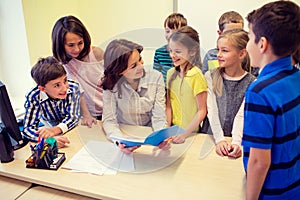 Group of school kids with teacher in classroom