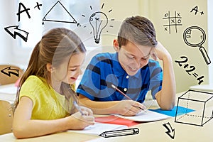 Group of school kids writing test in classroom