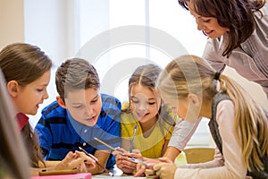 Group of school kids writing test in classroom photo