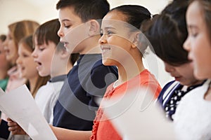 Group Of School Children Singing In Choir At Stage School Together photo