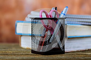 Group of school supplies and books over wood background