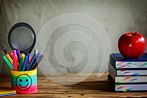 Group of school supplies and books and red apple over on background.School, stationary, equipment.