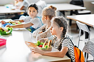 group of schoolgirls taking lunch at school