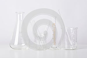 Group of scientific laboratory glassware with clear liquid solution