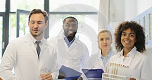 Group Of Scientist Happy Smiling Walk In Laboratory After Analyzing Chemicals Test Tube Results Of Research Experiment