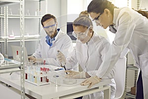 Group of scientists conducting an experiment in a pharma or biotech science laboratory
