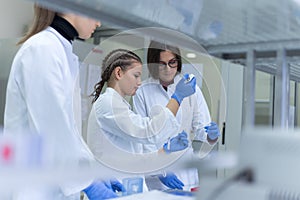 A group of scientists conducts research in a scientific laboratory using advanced technology. COVID-19. COVID Coronavirus