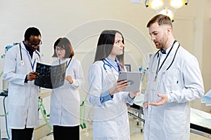 Group of scientists examining data on paper