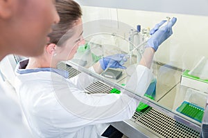 Group of scientists in research laboratory working under splashb