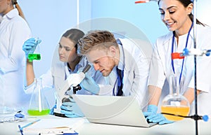 Group of scientists working in chemistry laboratory