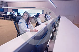 Group of security guards working on computers while sitting in the main control room, CCTV surveillance