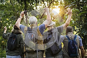 Group of senior adults trekking in the forest