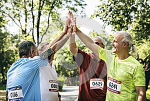 Group of senior athletes giving a high five