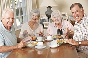 Group Of Senior Couples Enjoying Meal Together