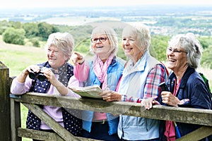 Group Of Senior Female Friends Hiking In Countryside