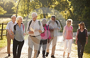 Group Of Senior Friends Hiking In Countryside