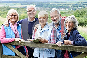 Group Of Senior Friends Hiking In Countryside