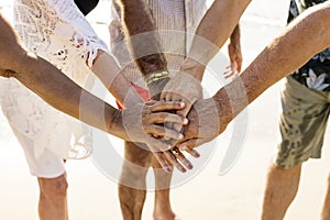 Group of senior friends stacking hands