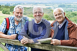 Group Of Senior Male Friends Hiking In Countryside