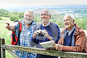 Group Of Senior Male Friends Hiking In Countryside