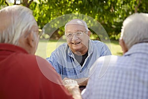 Group of senior men having fun and laughing in park photo