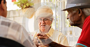 Group Of Senior Men Playing Cards Game