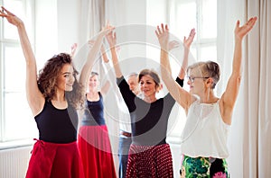 Group of senior people in dancing class with dance teacher.