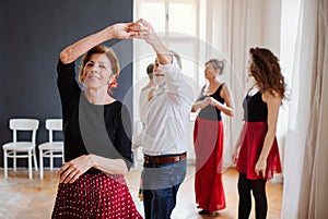 Group of senior people in dancing class with dance teacher.