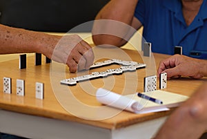 Group of senior people in retirement home playing domino