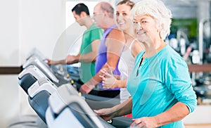 Group with senior people on treadmill in gym