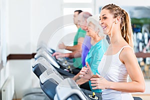 Group with senior people on treadmill in gym