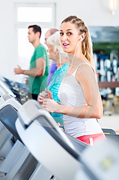 Group with senior people on treadmill in gym