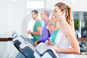 Group with senior people on treadmill in gym