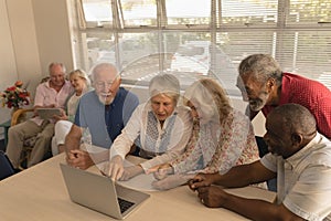 Group of senior people using laptop at nursing home