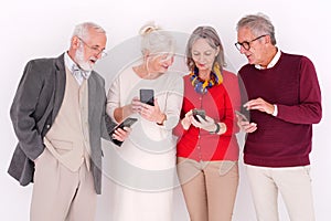 Group of senior women and man using mobile phones