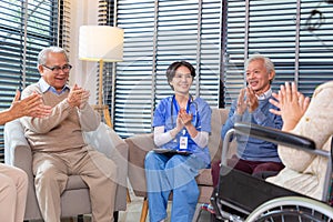 Group of Seniors clapping hands in a retirement home